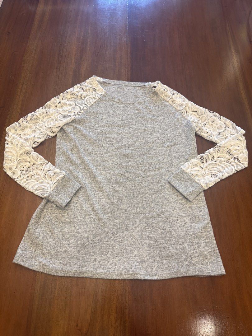 Gray Blouse with Lace Sleeves (Category: Blouses) located in Mandaue City. Submitted by marginiz (Listing ID 1421680005, Image 1). Description: - Gray blouse with white lace sleeves - Features a round neckline - Long sleeves - Length: 25 inches - Width: 16 inches - Contrasting white lace sleeves.