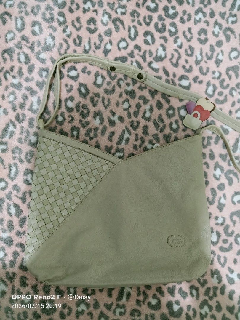 Ibiza Shoulder Bag (Category: Shoulder Bags) located in Quezon City. Submitted by daisyuy1979 (Listing ID 1421734051, Image 1). Description: - Ibiza shoulder bag with woven detail - Main compartment with zipper closure - Interior pocket - Long strap - Includes a small charm - Exterior shows marks and discoloration - Patterned interior lining - Sign of usage on outer part .