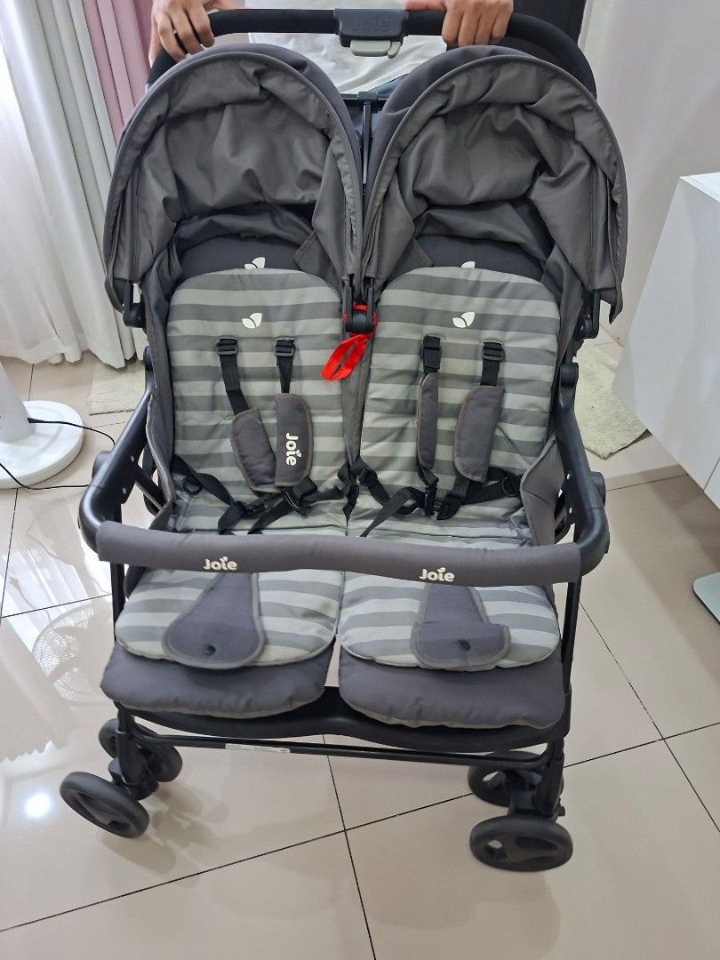 Joie Aire Twin Stroller (Category: Strollers) located in Quezon City. Submitted by livewolf_be901d (Listing ID 1421679071, Image 2). Description: - Joie Aire Twin double stroller - Two seats with striped padding - Equipped with safety harnesses - Dark gray frame and canopy - Features the Joie logo - Ideal for two children.