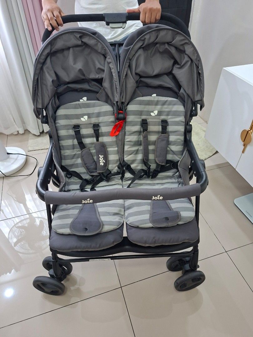 Joie Aire Twin Stroller (Category: Strollers) located in Quezon City. Submitted by livewolf_be901d (Listing ID 1421679071, Image 1). Description: - Joie Aire Twin double stroller - Two seats with striped padding - Equipped with safety harnesses - Dark gray frame and canopy - Features the Joie logo - Ideal for two children.