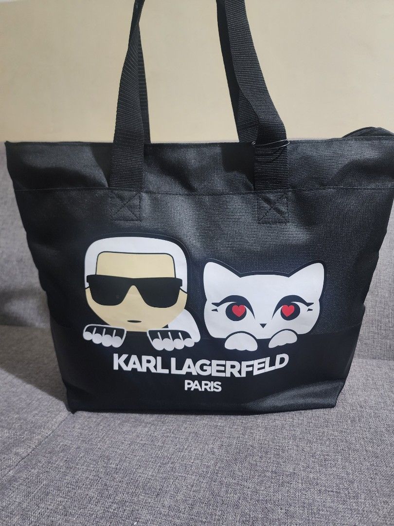 Karl Lagerfeld Black Polyester Canvas Tote Bag (Category: Tote Bags) located in Quezon City. Submitted by sebbysgoodsfromusa (Listing ID 1421686541, Image 1). Description: - Karl Lagerfeld black tote bag - Zippered main compartment - Exterior pocket - Interior pockets for organization - Karl Lagerfeld logo on front - Includes tag - Made in Thailand Bag can be used for luggage (provision to insert in luggage bag trolley handle) Approximate dimensi