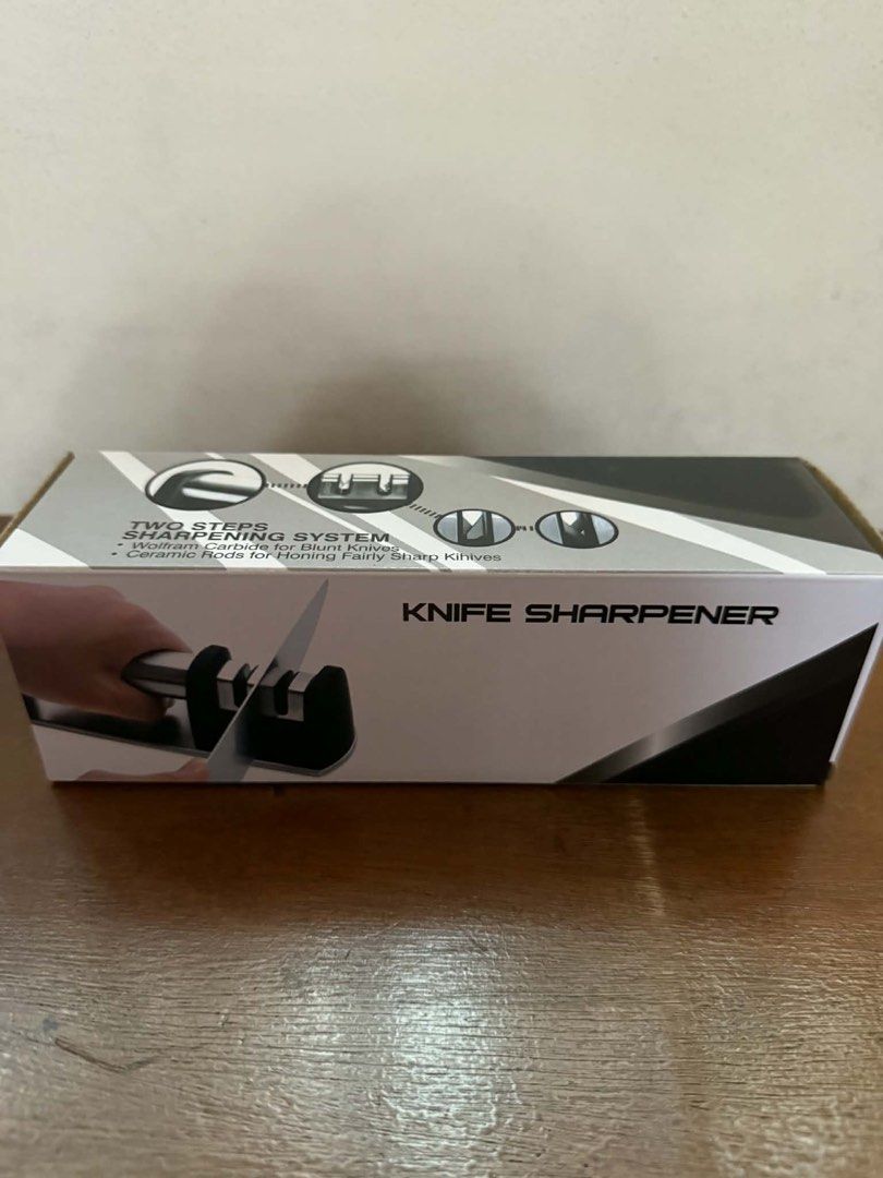 Knife Sharpener Two Steps Sharpening System (Category: Knives & Chopping Boards) located in Imus. Submitted by silentfire-353921 (Listing ID 1421633824, Image 1). Description: Knife sharpener features a two-step sharpening system. It uses Wolfram Carbide for blunt knives and ceramic rods for honing fairly sharp knives. The product is designed to sharpen your knives effectively. It is a practical tool for maintaining the sharpness of your kitchen 