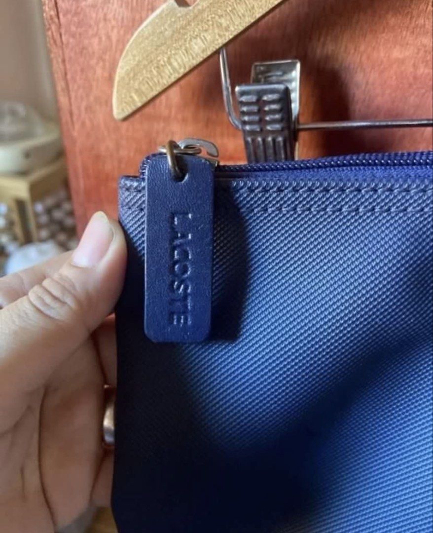 Lacoste Navy Blue Tote Bag (Category: Tote Bags) located in Taguig. Submitted by stuffitlikeitshot (Listing ID 1421704762, Image 3). Description: - Navy blue Lacoste tote bag - Zippered main compartment - Interior pocket - Lacoste logo on front - Lacoste logo on zipper pull - Lacoste logo printed interior lining - see last pic for FLAWS.