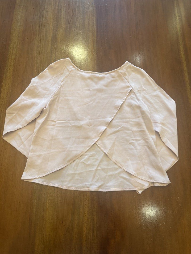 Light Pink Long Sleeve Blouse (Category: Blouses) located in Cebu City. Submitted by marginiz (Listing ID 1421675213, Image 2). Description: Light pink blouse features long sleeves and a unique back design. The blouse has a relaxed fit and is suitable for various occasions. Measurements are provided in the images for reference. It's a versatile piece that can be dressed up or down. Note: tag removed for comfort.