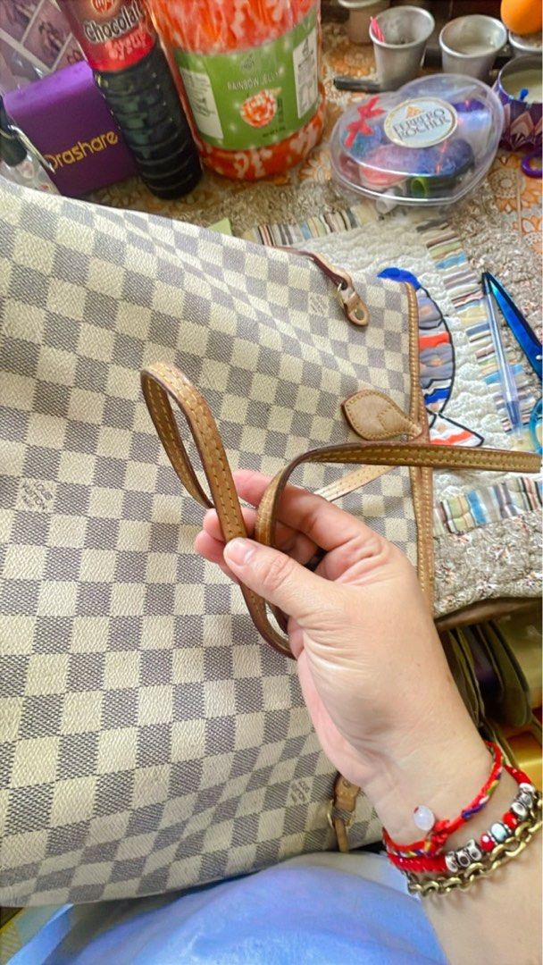 Louis Vuitton Damier Azur Tote Bag (Category: Luxury Bags & Wallets) located in Tuguegarao City. Submitted by bashapopoy87681 (Listing ID 1421633651, Image 2). Description: - Authentic Louis Vuitton Damier Azur tote bag - Classic white and gray Damier Azur checkered pattern - Light brown leather handles and trim - Striped interior lining with a zippered pocket.