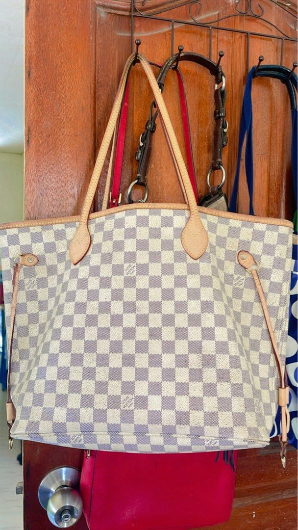 Louis Vuitton Damier Azur Tote Bag (Category: Luxury Bags & Wallets) located in Tuguegarao City. Submitted by bashapopoy87681 (Listing ID 1421633651, Image 1). Description: - Authentic Louis Vuitton Damier Azur tote bag - Classic white and gray Damier Azur checkered pattern - Light brown leather handles and trim - Striped interior lining with a zippered pocket.
