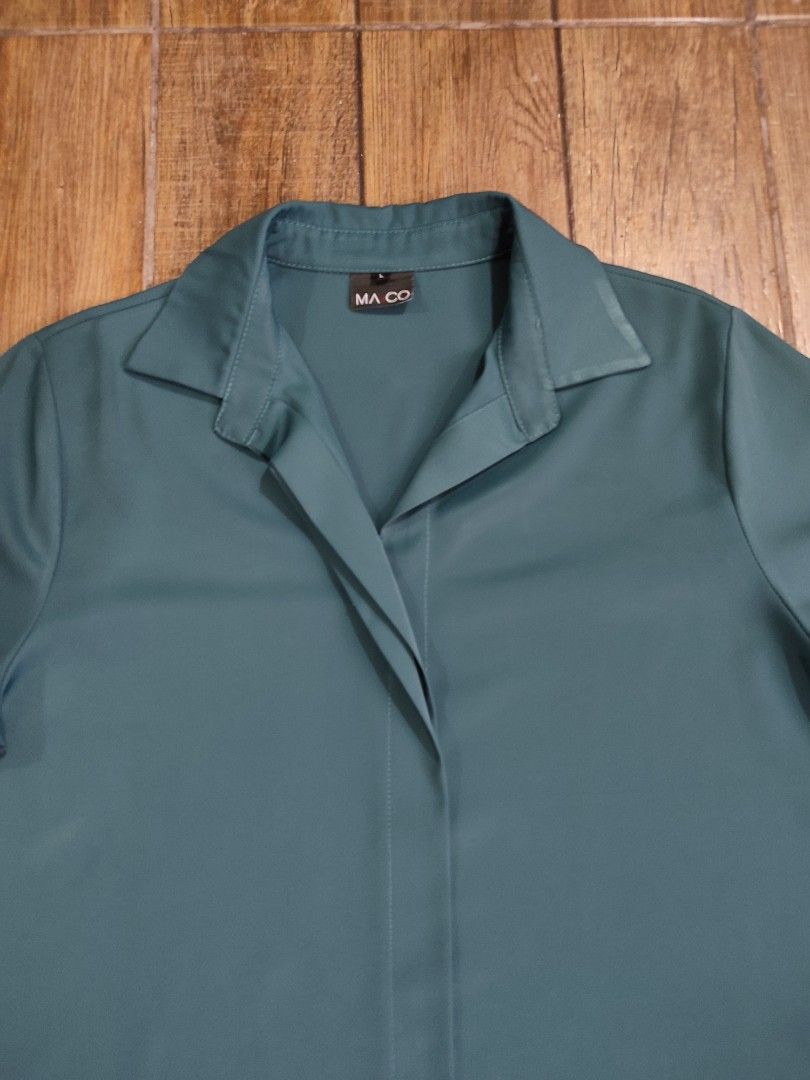 MA CO Teal Short Sleeve Top (Category: Blouses) located in Dasmarinas. Submitted by sbtt_ (Listing ID 1421639674, Image 2). Description: - MA CO. teal short sleeve top - Collared neckline - Button-down design - Relaxed fit - Smooth, likely synthetic fabric - Solid teal color - Brand tag visible.