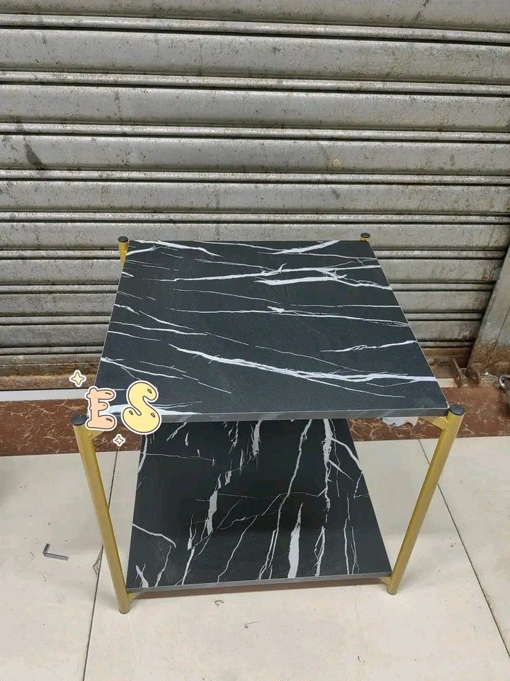Marble Top Side Table with Gold Frame (Category: Tables & Sets) located in Makati City. Submitted by oideme (Listing ID 1421643614, Image 2). Description: - Stylish side table - Marble-look top - Gold-colored metal frame - Second shelf for storage - Available in black and white marble designs - Square-shaped - Ideal for living rooms and bedrooms.