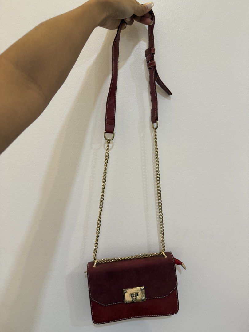 Maroon Shoulder Bag with Gold Chain (Category: Shoulder Bags) located in Quezon City. Submitted by reeseberrychic (Listing ID 1421642455, Image 1). Description: - Maroon shoulder bag - Gold chain strap - Gold-colored clasp - Two-tone design (darker flap, lighter body) - Visible stitching - Small side zipper.