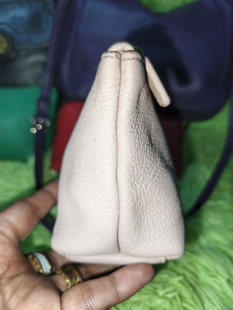 MCM Crossbody Pouch (Category: Luxury Bags & Wallets) located in Davao. Submitted by ukaystuff07 (Listing ID 1421781130, Image 3). Description: - Authentic MCM crossbody pouch - Light pink color - Gold-tone zipper - MCM logo on front - Pink satin-like interior lining - Includes MCM tag - Comes with a strap for easy carrying -issue :light faded parts upper part near zipper.
