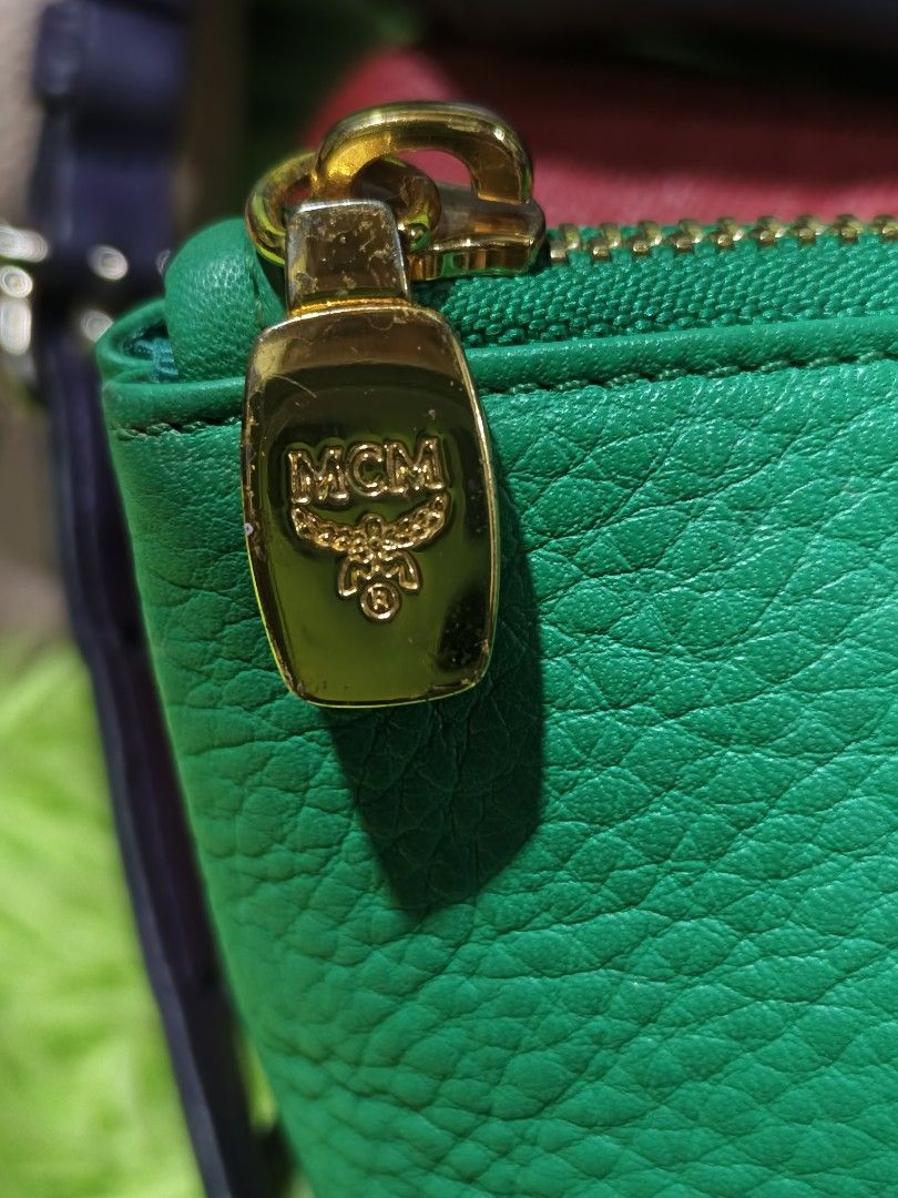 MCM Green Pouch (Category: Luxury Bags & Wallets) located in Davao. Submitted by ukaystuff07 (Listing ID 1421781183, Image 3). Description: - Authentic MCM pouch - Vibrant green color - Gold-toned zipper - MCM logo on front - Matching green satin-like interior lining - Made of textured leather - Rectangular shape with flat bottom -excellent condition.