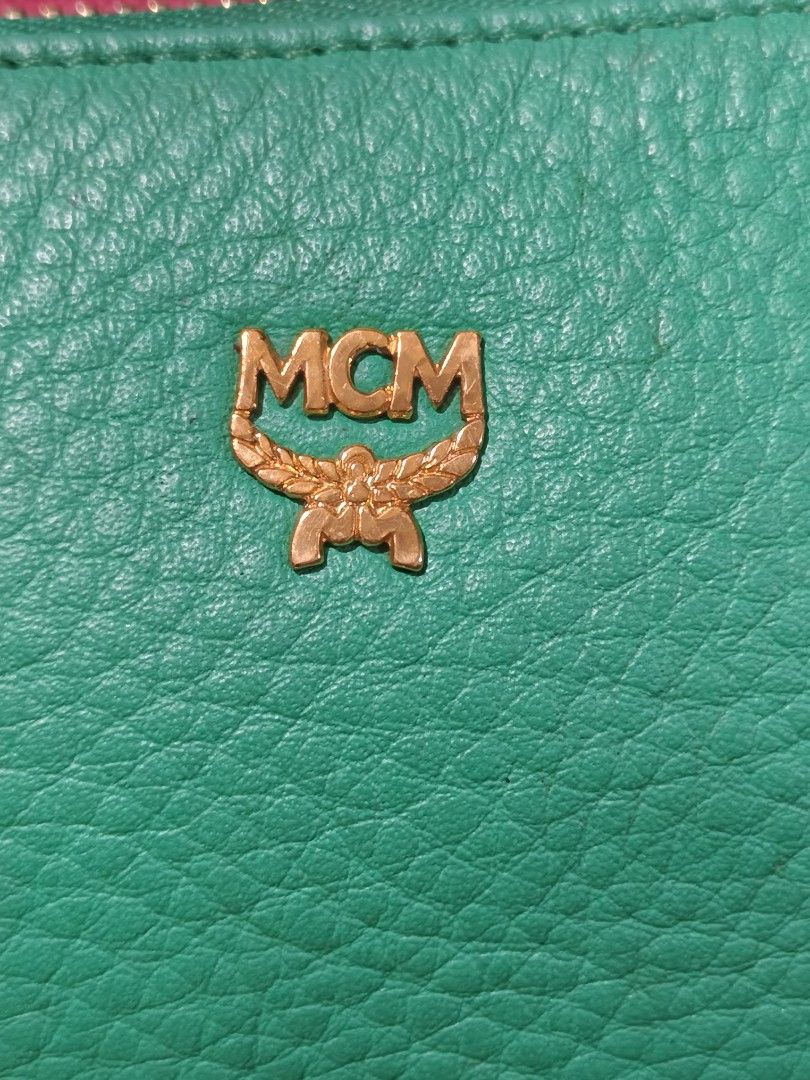 MCM Green Pouch (Category: Luxury Bags & Wallets) located in Davao. Submitted by ukaystuff07 (Listing ID 1421781183, Image 2). Description: - Authentic MCM pouch - Vibrant green color - Gold-toned zipper - MCM logo on front - Matching green satin-like interior lining - Made of textured leather - Rectangular shape with flat bottom -excellent condition.