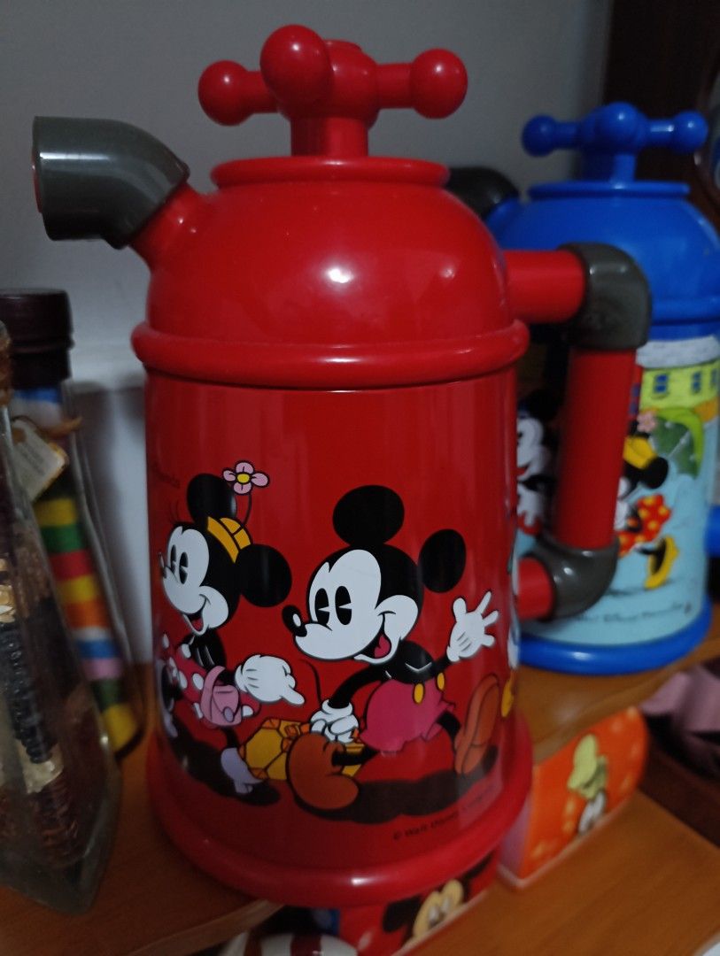 Mickey Mouse Thermos (Category: Pitchers & Dispensers) located in Caloocan City. Submitted by ira_28 (Listing ID 1421461313, Image 1). Description: Mickey Mouse Thermos - Features iconic Disney characters - Red body with a convenient handle - Tap-like design on top - Colorful design featuring Donald Duck and friends - Perfect collectible for Disney enthusiasts.