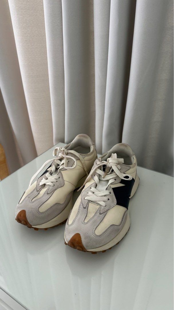 New Balance 327 Sneakers (Category: Sneakers) located in Santa Rosa. Submitted by declutterbydl (Listing ID 1421683093, Image 2). Description: - New Balance 327 - Cream and grey colorway - Navy blue logo - Size tag visible in photos - White laces - Brown sole.