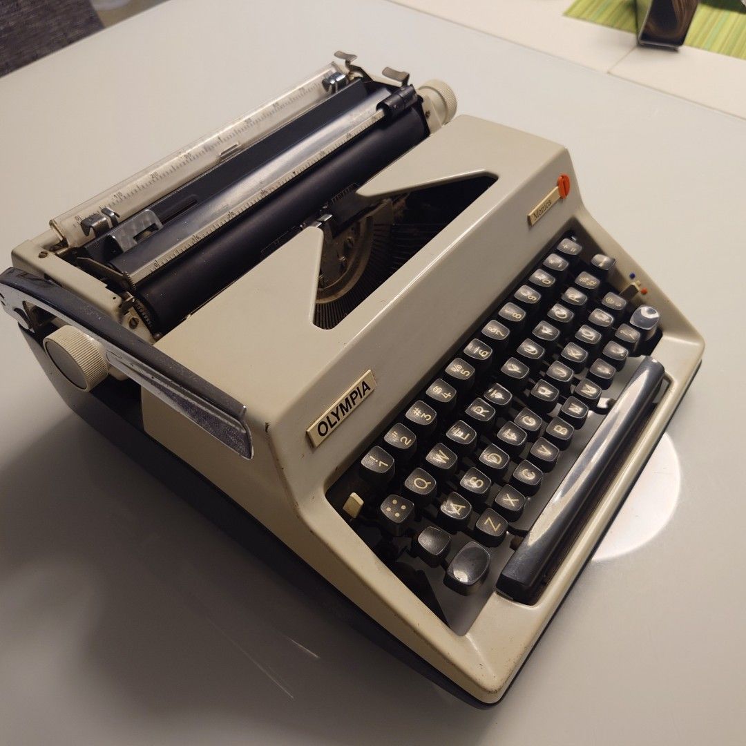 Olympia Monica Typewriter (Category: Office & Business Technology) located in Makati City. Submitted by ppomidyar (Listing ID 1421691901, Image 2). Description: - Vintage Olympia Monica typewriter - QWERTY keyboard - Cream-colored body with black keys - Includes carrying case - Made in Western Germany - Black carrying case with handle and lock - Olympia International logo visible - Made in West Germany - circa 1964-1972 model before German unific