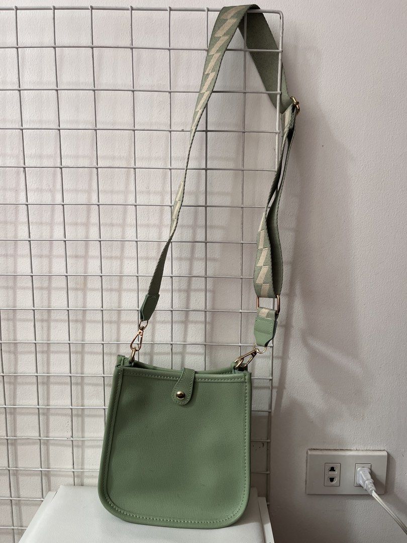 Parisian Green Crossbody Bag (Category: Cross-body Bags) located in Antipolo. Submitted by sldchloe_declutters (Listing ID 1421645838, Image 3). Description: - Stylish green crossbody bag - From Parisian - Patterned green and beige strap - Magnetic snap closure - Interior zipper pocket - Minor mark on front.
