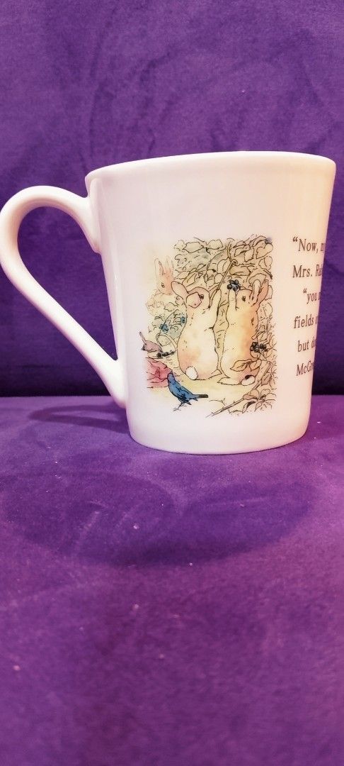 Peter Rabbit Ceramic Mug (Category: Coffee & Tea Tableware) located in Cabanatuan. Submitted by miss.maia (Listing ID 1421760723, Image 2). Description: Charming ceramic mug features illustrations from "The World of Peter Rabbit." The mug showcases scenes with Mrs. Rabbit and her children, along with quotes from the story. The base of the mug has the Peter Rabbit logo and Beatrix Potter's name. Perfect for fans of the classic children's tale..