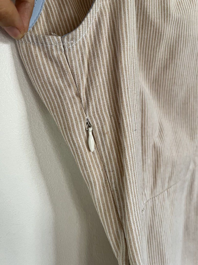 Plains & Prints Striped Sleeveless Top (Category: Sleeveless) located in San Fernando. Submitted by 4ases.declutter (Listing ID 1421638605, Image 3). Description: - Plains & Prints sleeveless top - Beige and white striped pattern - Asymmetrical design - Side zipper closure - Keyhole back detail - Floral embellishment - Size: PHL XS, EUR 6, USA 2.
