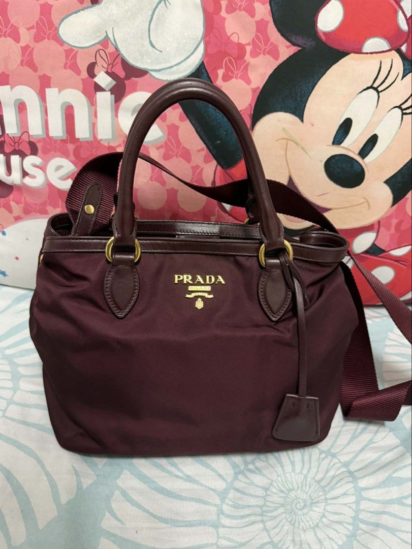 Prada Tessuto Handbag with Shoulder Strap (Category: Luxury Bags & Wallets) located in Taguig. Submitted by bncdnc (Listing ID 1421750534, Image 2). Description: Prada tessuto 2 way hand/cross body bag In good condition Nylon material Color Maroon With cards With dustbag Guaranteed Authentic. Prices are still negotiable. 🙂 .