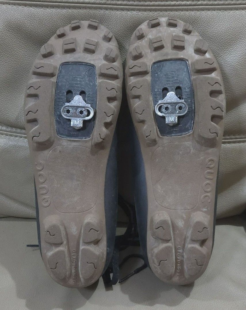 QUOC Cycling Shoes (Category: Other Sports Equipment and Supplies) located in Quezon City. Submitted by ddlry (Listing ID 1421702867, Image 2). Description: -size 45 - QUOC cycling shoes - Color: Black - Design: Lace-up - Sole: Brown - Cleats for secure pedal attachment - Perforated design for breathability - Brand name visible on insole and sole.