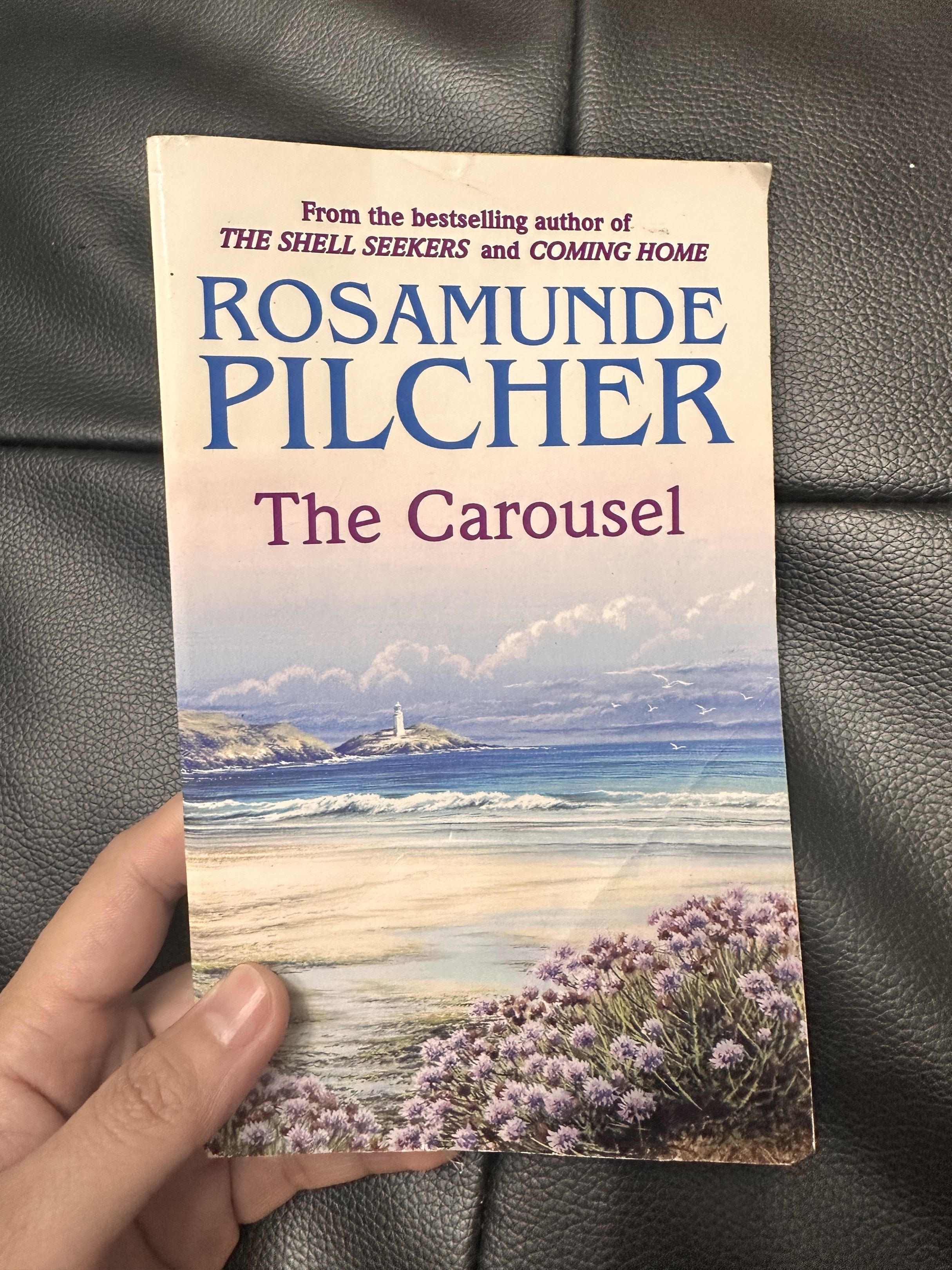 Rosamunde Pilcher The Carousel Book (Category: Storybooks) located in Paranaque City. Submitted by kashireadsbookstore (Listing ID 1421629091, Image 1). Description: - "The Carousel" by Rosamunde Pilcher - Features a beautiful coastal scene cover - Author known for "The Shell Seekers" and "Coming Home".