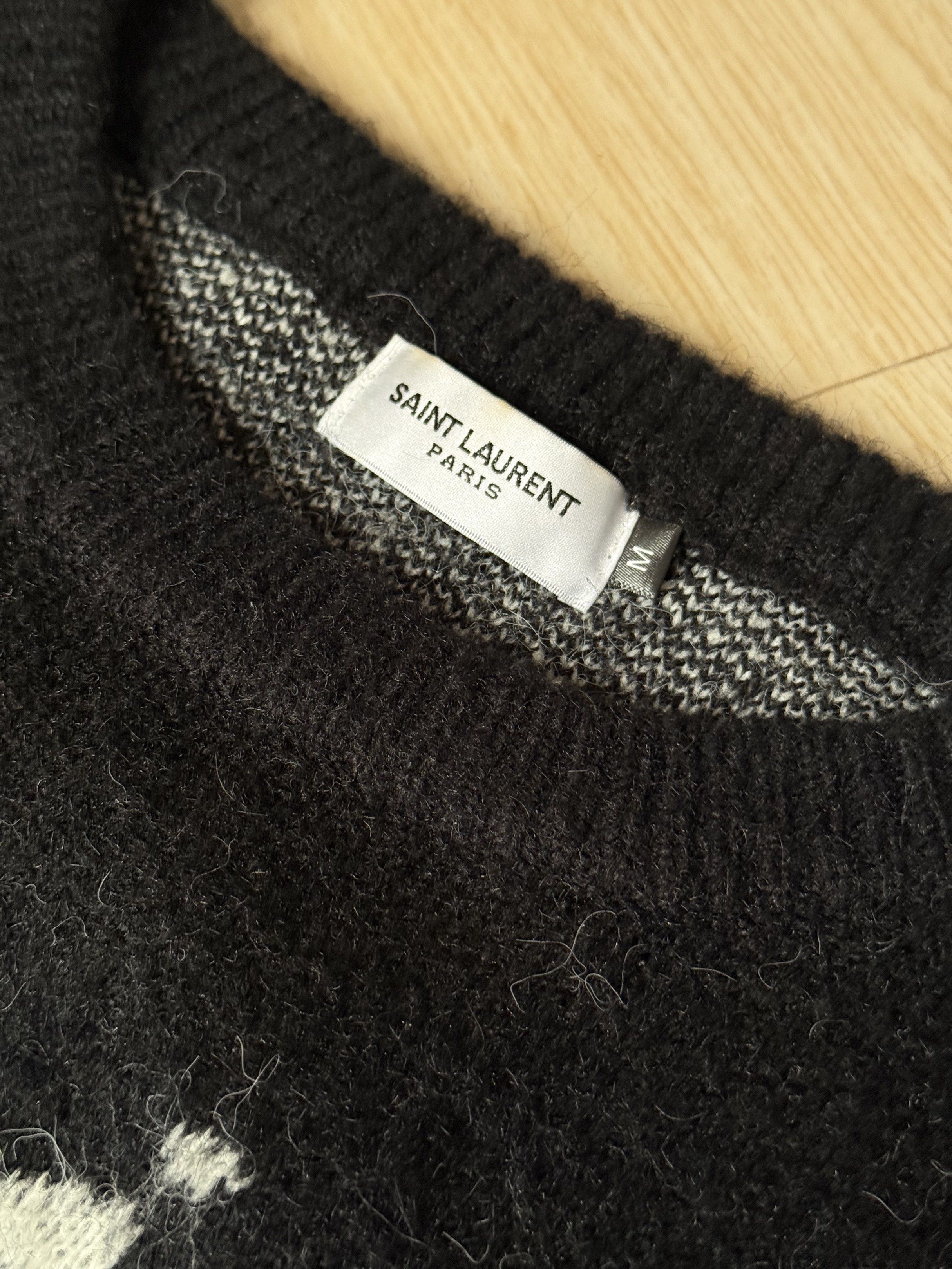 Saint Laurent Paris Sweater (Category: Luxury Apparel) located in Meycauayan. Submitted by jhonedrickso12 (Listing ID 1421633173, Image 3). Description: - Saint Laurent Paris sweater - Black with white lettering - Size: M - Crew neck - Long sleeves - Textured fabric.