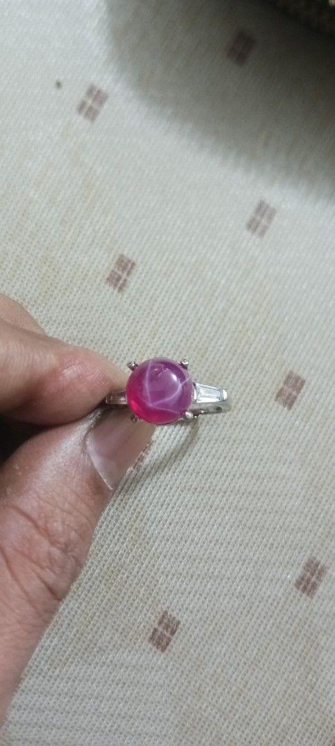 Star Ruby Ring (Category: Rings) located in Kota Kinabalu. Submitted by anas7389 (Listing ID 1421750199, Image 1). Description: - Stunning star ruby ring - Set in a silver band - Features a vibrant star ruby gemstone - Accented with two smaller rectangular stones - Simple and eye-catching design - Perfect for everyday wear or special occasions.