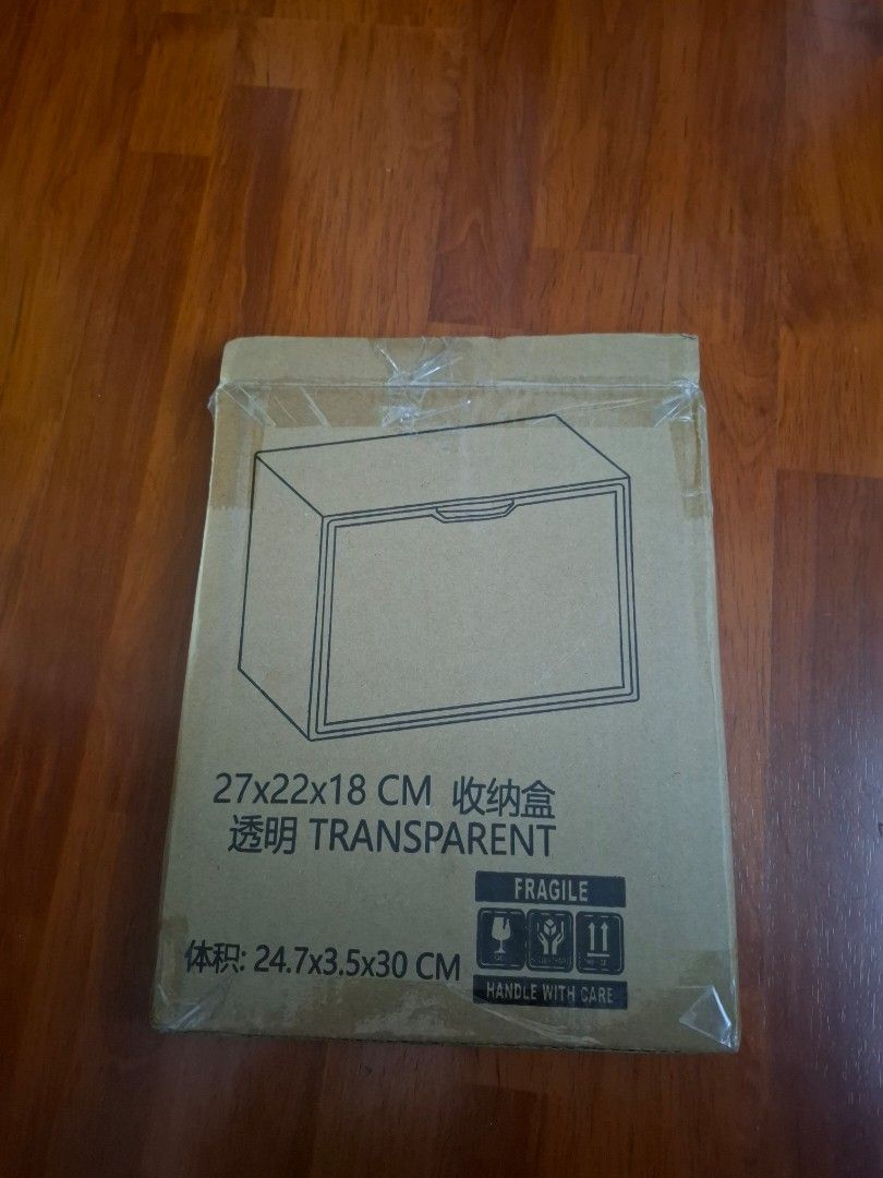 Transparent Storage Box 27x22x18cm (Category: Storage Boxes & Baskets) located in Cavite. Submitted by Kal_07 (Listing ID 1421645343, Image 1). Description: Welcome to our Shop! I'm selling this Transparent storage box. The dimensions are 27x22x18 cm. It is still in its original packaging. The box is marked with the dimensions 24.7x3.5x30 cm. It also has a handle with care label. The box is unopened, but never been used. RFS: Decluttering Courier