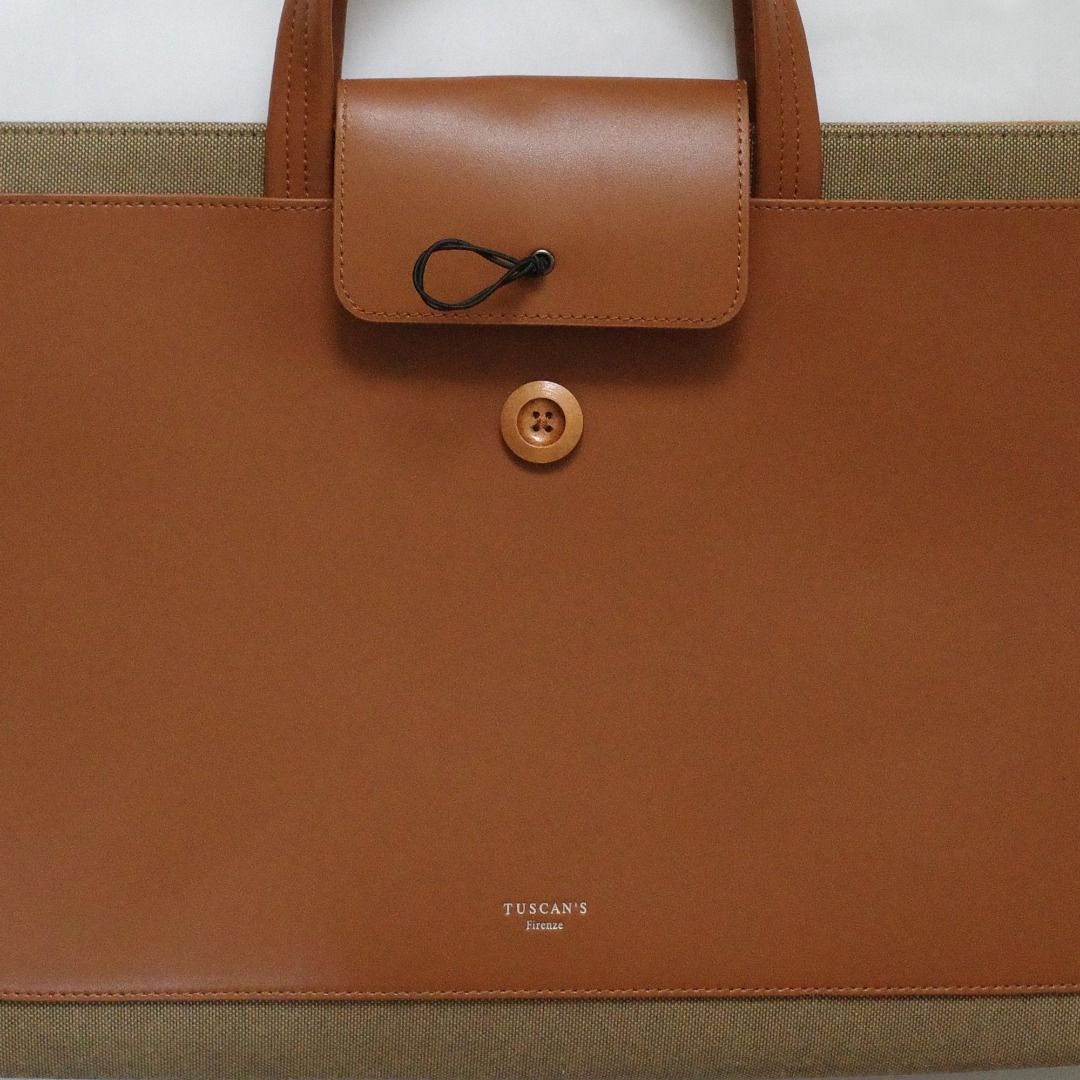 Tuscan's Leather Laptop Bag (Category: Laptop Bags & Sleeves) located in Paranaque City. Submitted by curated.by.bamekaji (Listing ID 1421694900, Image 3). Description: Tuscan's brown leather laptop bag. Features a button closure, leather handle, and tan suede interior. Multiple compartments inside. Good for 15.6" Laptop. - Minor dents on rear part leather - Good quality and worksmanship.