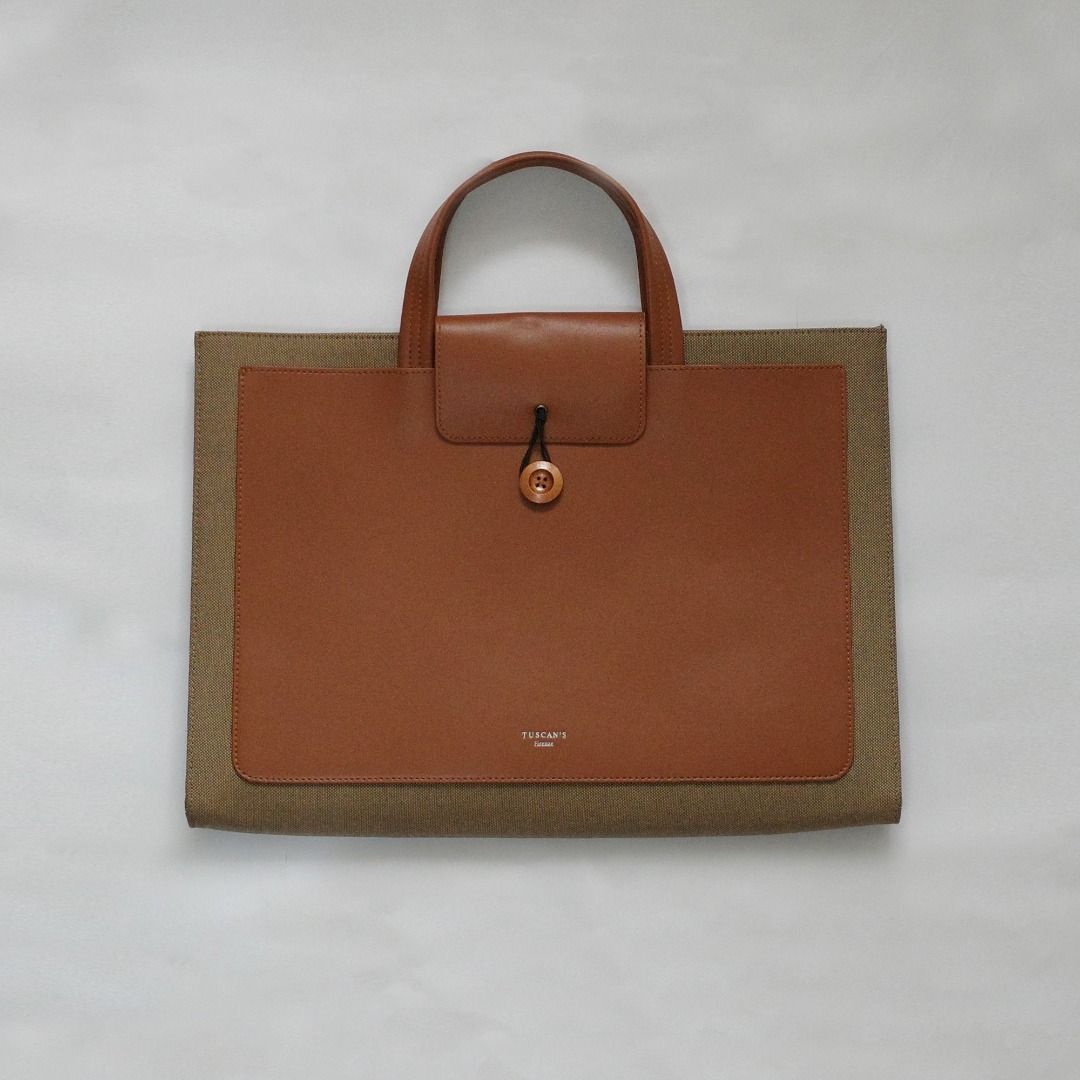 Tuscan's Leather Laptop Bag (Category: Laptop Bags & Sleeves) located in Paranaque City. Submitted by curated.by.bamekaji (Listing ID 1421694900, Image 1). Description: Tuscan's brown leather laptop bag. Features a button closure, leather handle, and tan suede interior. Multiple compartments inside. Good for 15.6" Laptop. - Minor dents on rear part leather - Good quality and worksmanship.