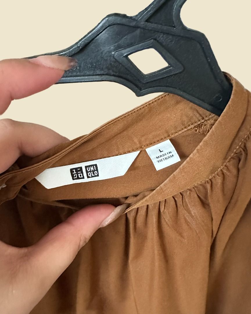 Uniqlo Brown Longsleeves Blouse (Category: Blouses) located in Muntinlupa City. Submitted by mmorjo (Listing ID 1421711198, Image 2). Description: NEVER USED - Uniqlo blouse - Warm brown color - Size: L - Round neckline - Three-quarter sleeves with elastic cuffs - Relaxed fit - Made in Vietnam.