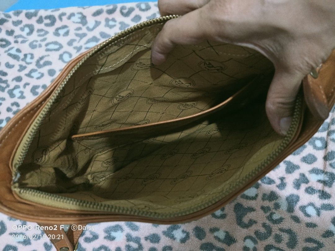 Vintage Shoulder Bag (Category: Shoulder Bags) located in Quezon City. Submitted by uydaisy1979 (Listing ID 1421734821, Image 3). Description: - Vintage shoulder bag - Green canvas body - Brown leather accents - Long, adjustable strap - Zippered main compartment - Patterned interior lining - Additional pocket inside - Shows some signs of wear.
