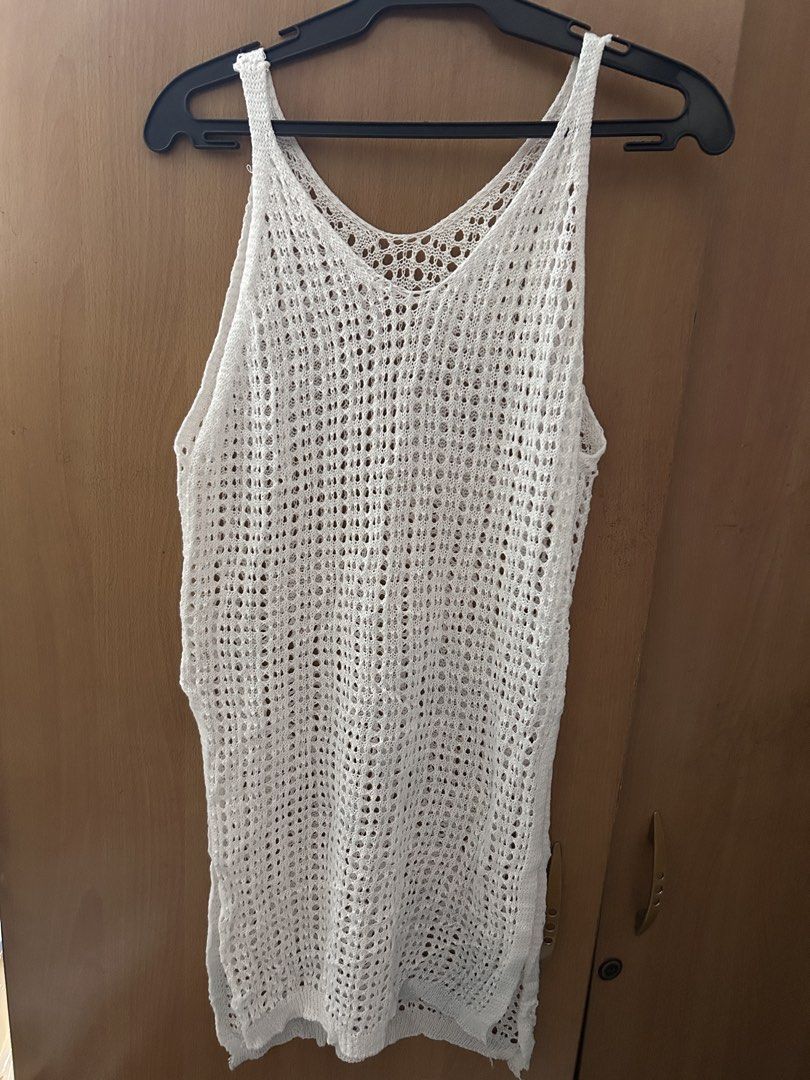 White Crochet Cover-up (Category: Bikinis & Swimsuits) located in Pasay City. Submitted by volatile.waters (Listing ID 1421686718, Image 2). Description: - White crochet cover-up - V-neck design - Sleeveless style - Features side slits - Breathable, open-weave material - Ideal for beach or poolside - Mid-thigh length - with visible stains (can be bleached).