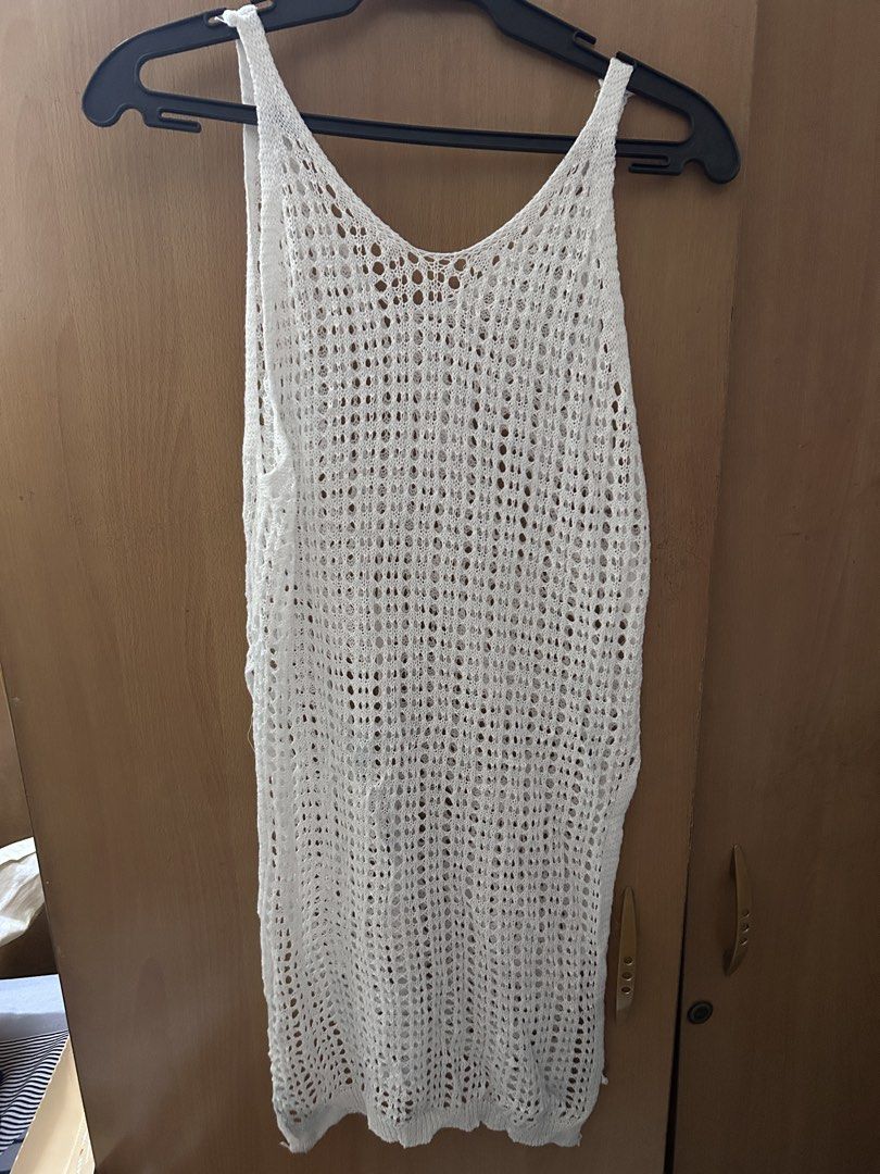 White Crochet Cover-up (Category: Bikinis & Swimsuits) located in Pasay City. Submitted by volatile.waters (Listing ID 1421686718, Image 3). Description: - White crochet cover-up - V-neck design - Sleeveless style - Features side slits - Breathable, open-weave material - Ideal for beach or poolside - Mid-thigh length - with visible stains (can be bleached).