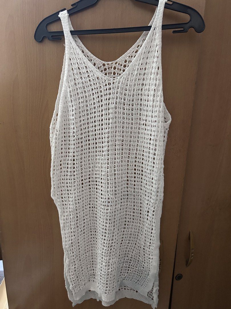 White Crochet Cover-up (Category: Bikinis & Swimsuits) located in Pasay City. Submitted by volatile.waters (Listing ID 1421686718, Image 1). Description: - White crochet cover-up - V-neck design - Sleeveless style - Features side slits - Breathable, open-weave material - Ideal for beach or poolside - Mid-thigh length - with visible stains (can be bleached).