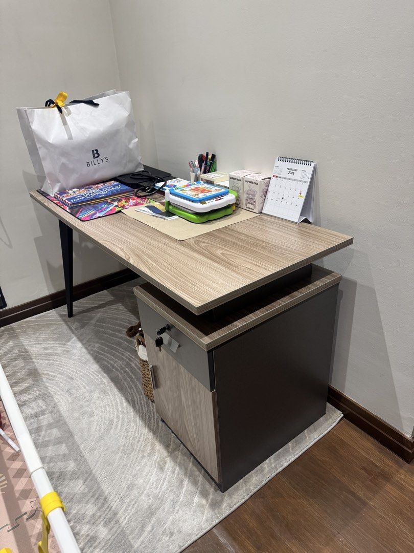 Wooden Office Desk with Cabinet (Category: Office Furniture & Fixtures) located in Manila. Submitted by ctluxefinds (Listing ID 1421724539, Image 2). Description: Light Used with minor issue, shown in the last photo Color : Walnut & Grey Size : L140 x W60 x H75cm 2 Side Drawers Pedestal, Key & Lock High Quality Drawer Railings .