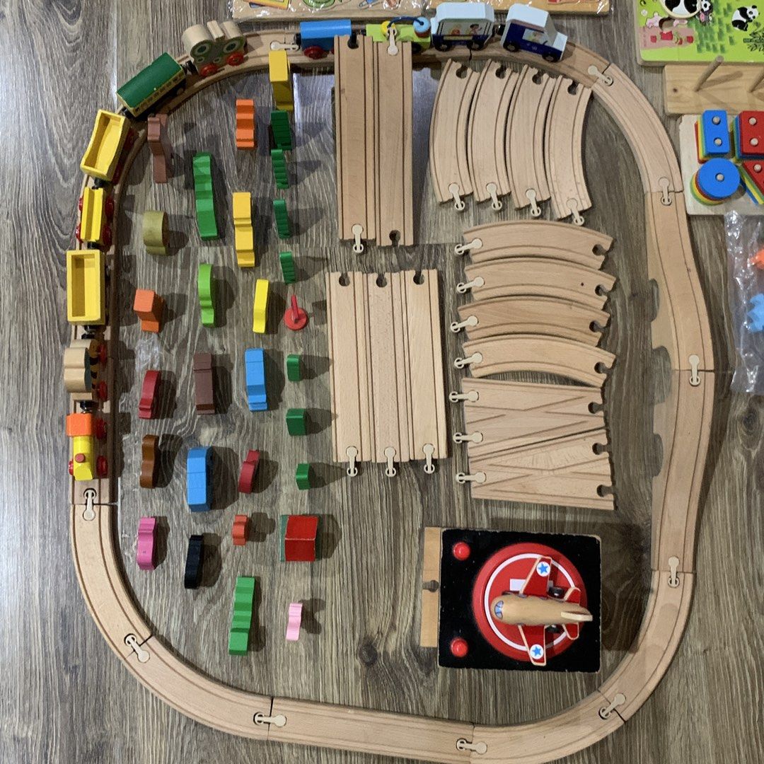 Wooden Train Set with Accessories (Category: Kids Toys) located in Davao. Submitted by decluttering.nurse (Listing ID 1421677054, Image 2). Description: - Wooden train set - Includes track pieces, trains, and animal figures - Features a hospital, trees, and other accessories - Complete set with multiple train cars and a bridge - Includes a fishing game.
