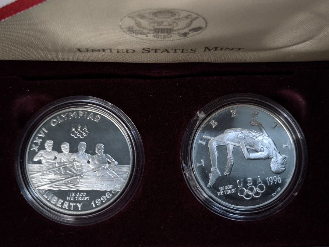 1996 US Olympic Two-Coin Silver Proof Set (Category: Currency) located in Paranaque City. Submitted by phcoincollective (Listing ID 1421920456, Image 1). Description: — 1996 US Olympic Two-Coin Silver Proof Set — Includes two silver proof coins — Complete box set with a Certificate of Authenticity from the United States Mint — Housed in a maroon presentation box — Features designs of a rowing team and a high jumper.