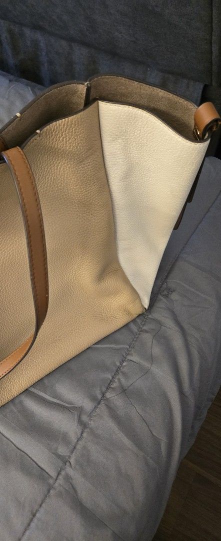 Authentic Michael Kors Tote Bag (Category: Tote Bags) located in Quezon City. Submitted by PreLovedByMrsAL (Listing ID 1421838532, Image 3). Description: - Neutral-colored tote bag with brown straps - Spacious interior - Unique design - Magnetic closure - Ideal for everyday use - can fit laptops - like neverfull - authentic and bought from rockwell - Used 2x - Shipping via grab or lalalmove - You may arrange J&T or LBC.