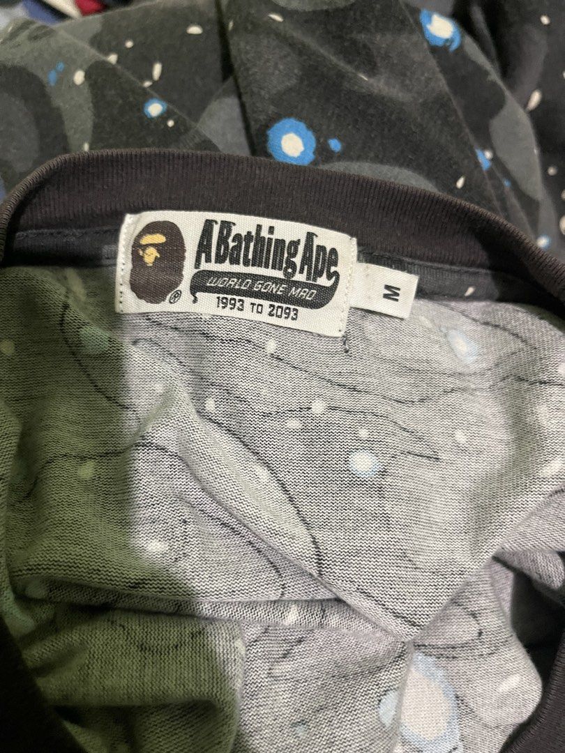 BAPE Galaxy Camo T-shirt (Category: Tshirts & Polo Shirts ) located in Bacolod City. Submitted by 1012.thrift (Listing ID 1421836195, Image 3). Description: -21x27 - Authentic BAPE T-shirt - Size: M - Design: Galaxy camo - Features the Ape Head logo - Colors: Dark grey, black, white, and blue accents - BAPE logo color: Light green - Issue: discoloration in neck line -1499 free ship -pwede fb transac thru vc.