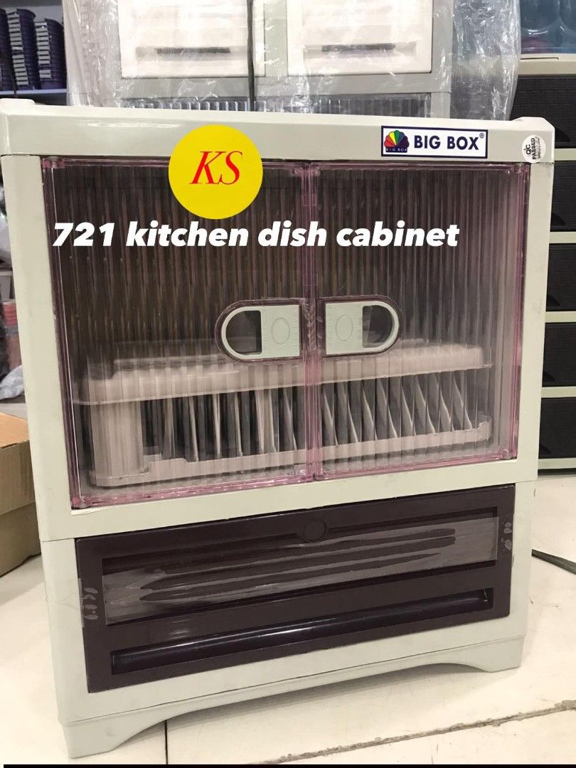 Big Box 721 Kitchen Dish Cabinet (Category: Other Kitchenware & Tableware) located in Taguig. Submitted by diannecaya86853 (Listing ID 1421918465, Image 1). Description: Big Box 721 kitchen dish cabinet is designed for storing dishes. It features a two-door cabinet with a dish rack and a drawer at the bottom. The cabinet has a clear front, allowing visibility of the contents. It is suitable for kitchen use..