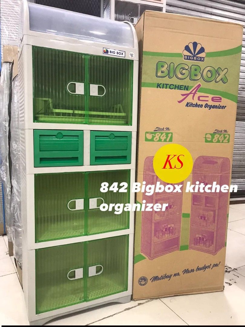 Bigbox Kitchen Ace 842 Kitchen Organizer (Category: Food Organization & Storage) located in Taguig. Submitted by diannecaya86853 (Listing ID 1421917818, Image 2). Description: Bigbox Kitchen Ace 842 kitchen organizer. It has a green and white color scheme. The organizer features two drawers and two cabinet doors. The product is new and still in its original packaging..
