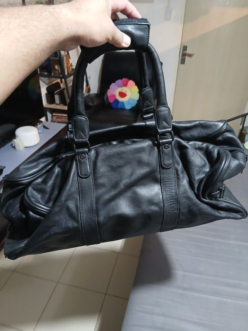 Condotti Black Leather Handbag (Category: Luxury Bags & Wallets) located in Pasay City. Submitted by bespokebyhypeves (Listing ID 1421918780, Image 3). Description: - Black leather handbag - Double handles - Rectangular shape - Zipper closure - Gold-colored tag - Strap detail on front and back.
