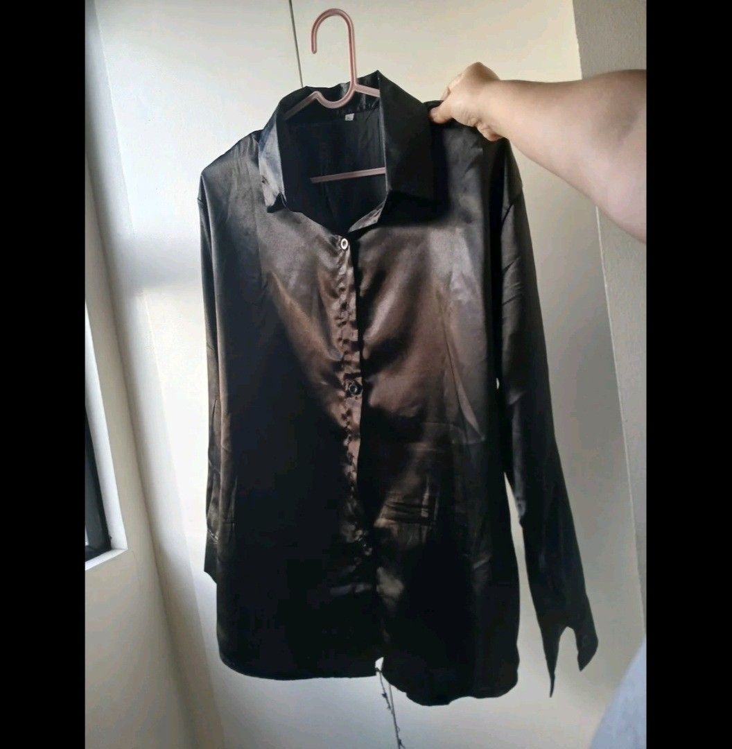 Black Satin Blouse (XL on tag) (Category: Blouses) located in Quezon City. Submitted by dyanella7 (Listing ID 1421819533, Image 2). Description: - Black satin blouse - Button-down design - Collared neckline - Long sleeves (rollable) - Suitable for formal and casual wear - Pairs well with jeans or skirts.