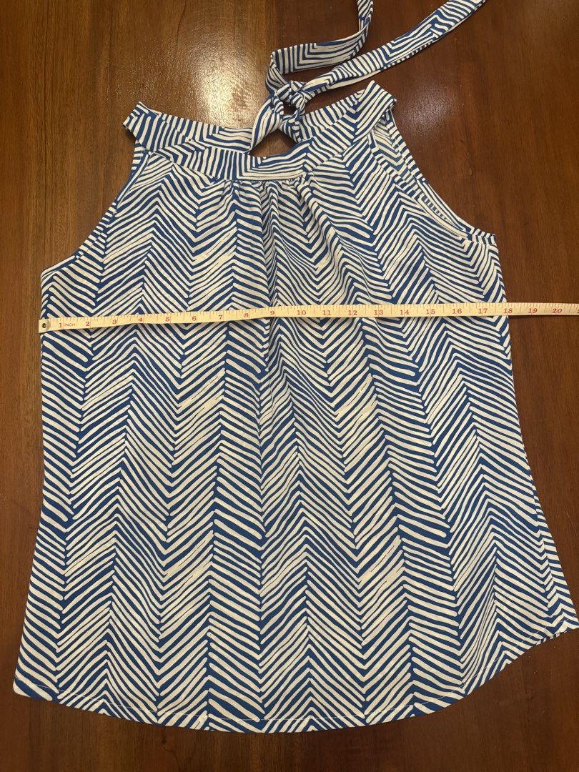 Blue and White Halter Top (Category: Sleeveless) located in Mandaue City. Submitted by marginiz (Listing ID 1421890432, Image 3). Description: Stylish halter top in a blue and white chevron pattern. Features a tie-back closure and a flattering neckline. The top measures approximately 18 inches across the chest and 23 inches in length. Perfect for a casual day out or a summer gathering. Made from a lightweight fabric, it offers a comfortable fit..