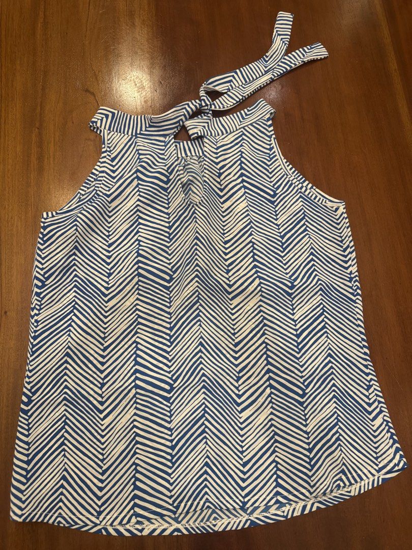Blue and White Halter Top (Category: Sleeveless) located in Mandaue City. Submitted by marginiz (Listing ID 1421890432, Image 2). Description: Stylish halter top in a blue and white chevron pattern. Features a tie-back closure and a flattering neckline. The top measures approximately 18 inches across the chest and 23 inches in length. Perfect for a casual day out or a summer gathering. Made from a lightweight fabric, it offers a comfortable fit..