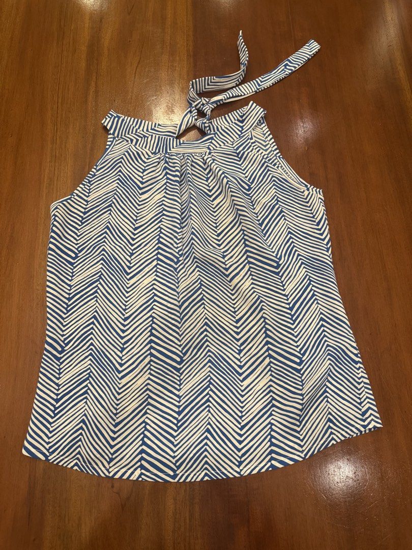 Blue and White Halter Top (Category: Sleeveless) located in Mandaue City. Submitted by marginiz (Listing ID 1421890432, Image 1). Description: Stylish halter top in a blue and white chevron pattern. Features a tie-back closure and a flattering neckline. The top measures approximately 18 inches across the chest and 23 inches in length. Perfect for a casual day out or a summer gathering. Made from a lightweight fabric, it offers a comfortable fit..