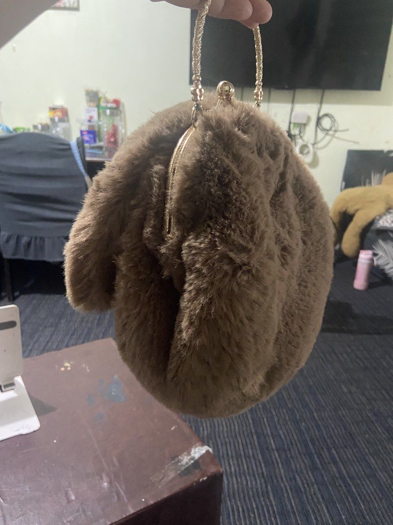 Brown Furry Handbag with Gold Handle (Category: Luxury Bags & Wallets) located in Pasig City. Submitted by khloe23 (Listing ID 1421851089, Image 2). Description: - Soft, brown furry exterior - Gold-colored handle - Unique round shape - Kiss-lock closure - Smooth, neutral-colored interior lining - Sturdy, circular handle - Perfect for adding flair to your look.