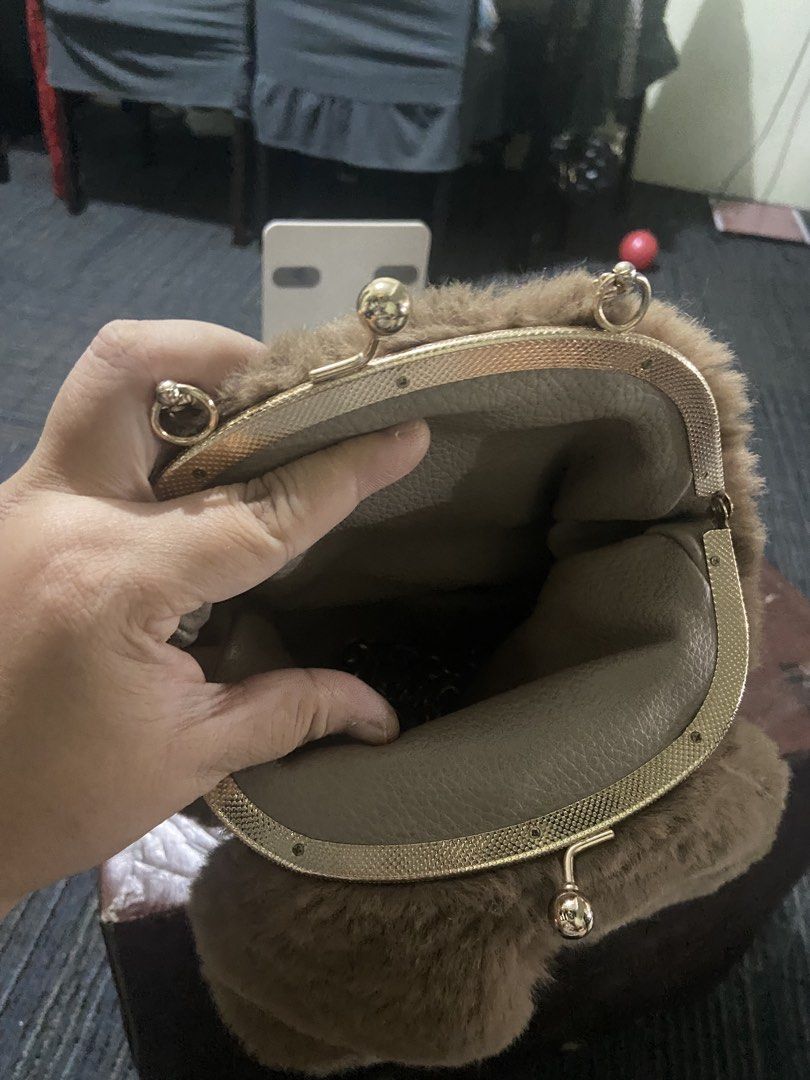 Brown Furry Handbag with Gold Handle (Category: Luxury Bags & Wallets) located in Pasig City. Submitted by khloe23 (Listing ID 1421851089, Image 3). Description: - Soft, brown furry exterior - Gold-colored handle - Unique round shape - Kiss-lock closure - Smooth, neutral-colored interior lining - Sturdy, circular handle - Perfect for adding flair to your look.