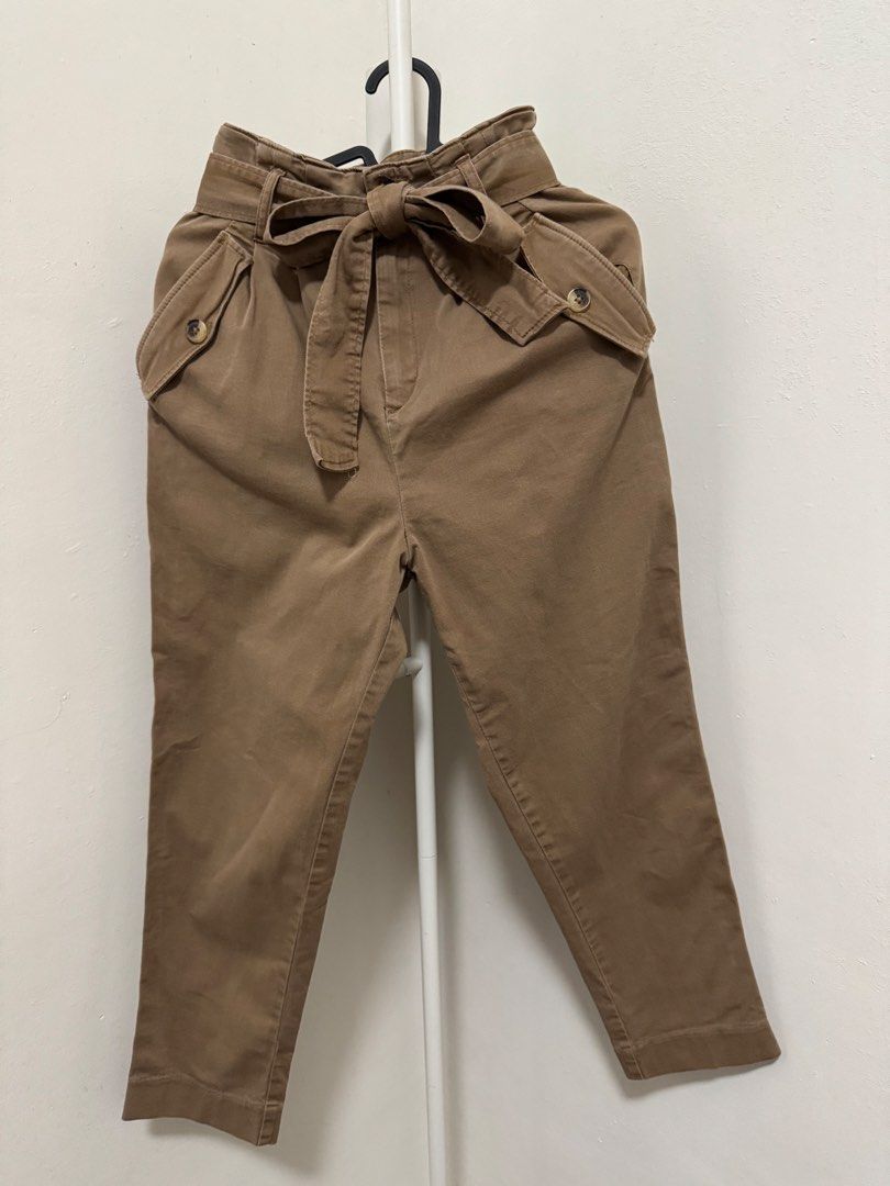 Brown Paper Bag Waist Pants (Category: Other Bottoms) located in Manila. Submitted by summer.731 (Listing ID 1421851584, Image 1). Description: Stylish brown pants with a paper bag waist design. Features a tie-waist detail and two front pockets. The pants have a cropped length and a tailored fit. The back of the pants has a clean, simple design. Perfect for creating a chic and versatile look..